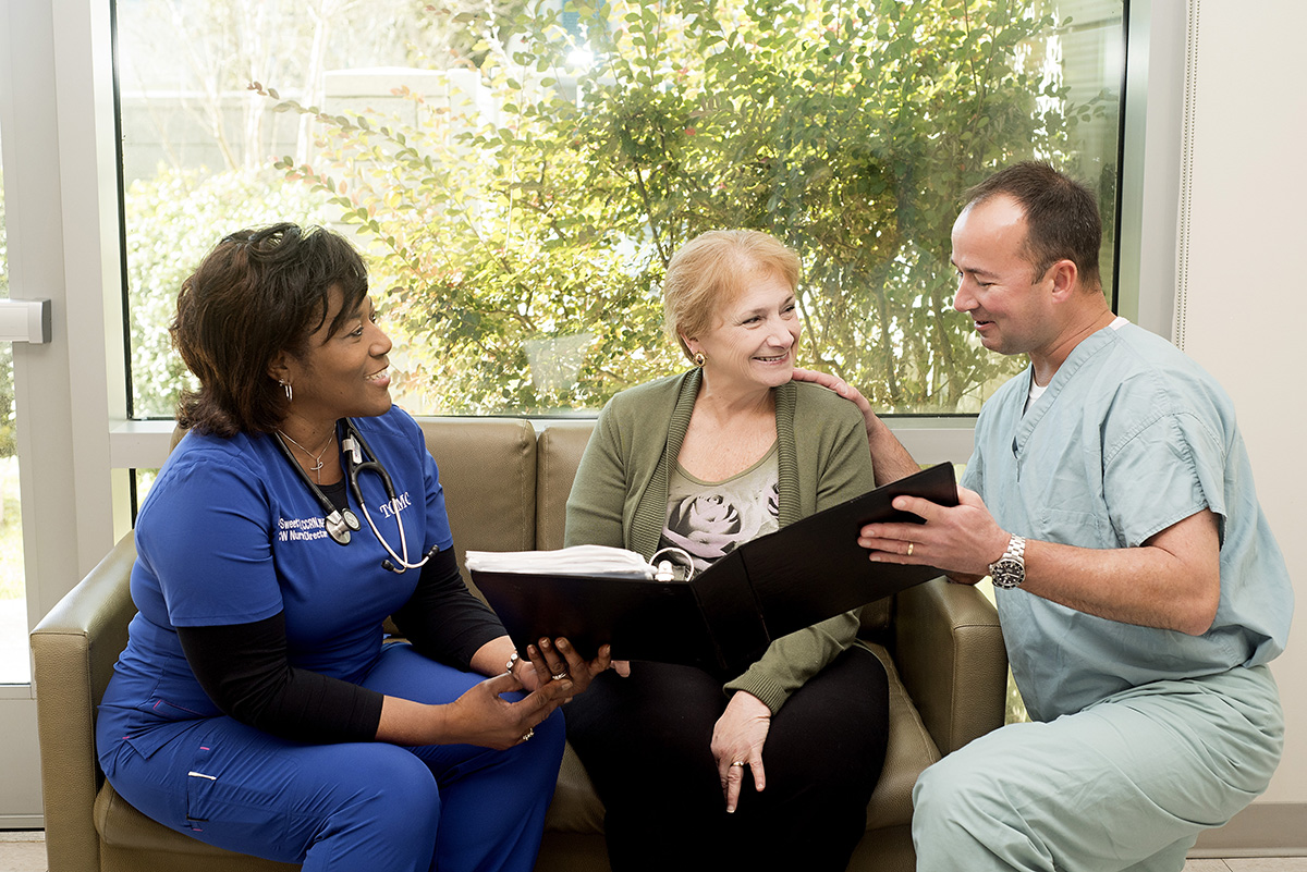 Smiling patient with nurses 