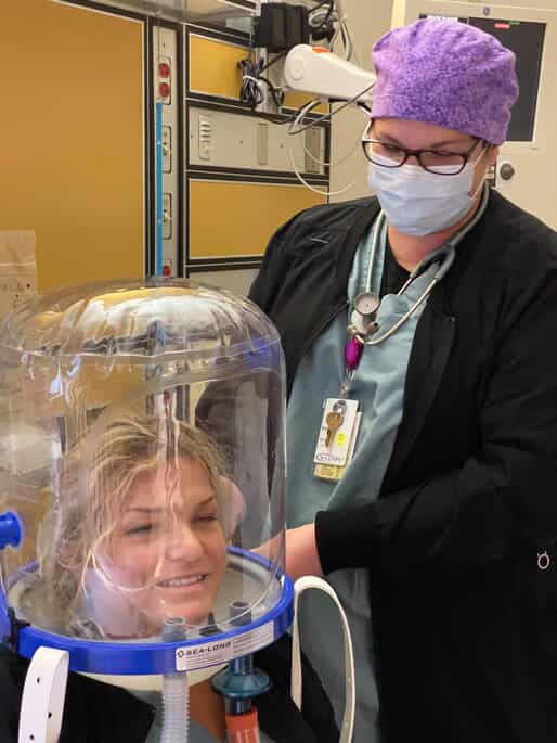 Respiratory Therapist demonstrates the non-invasive breathing mask technology.
